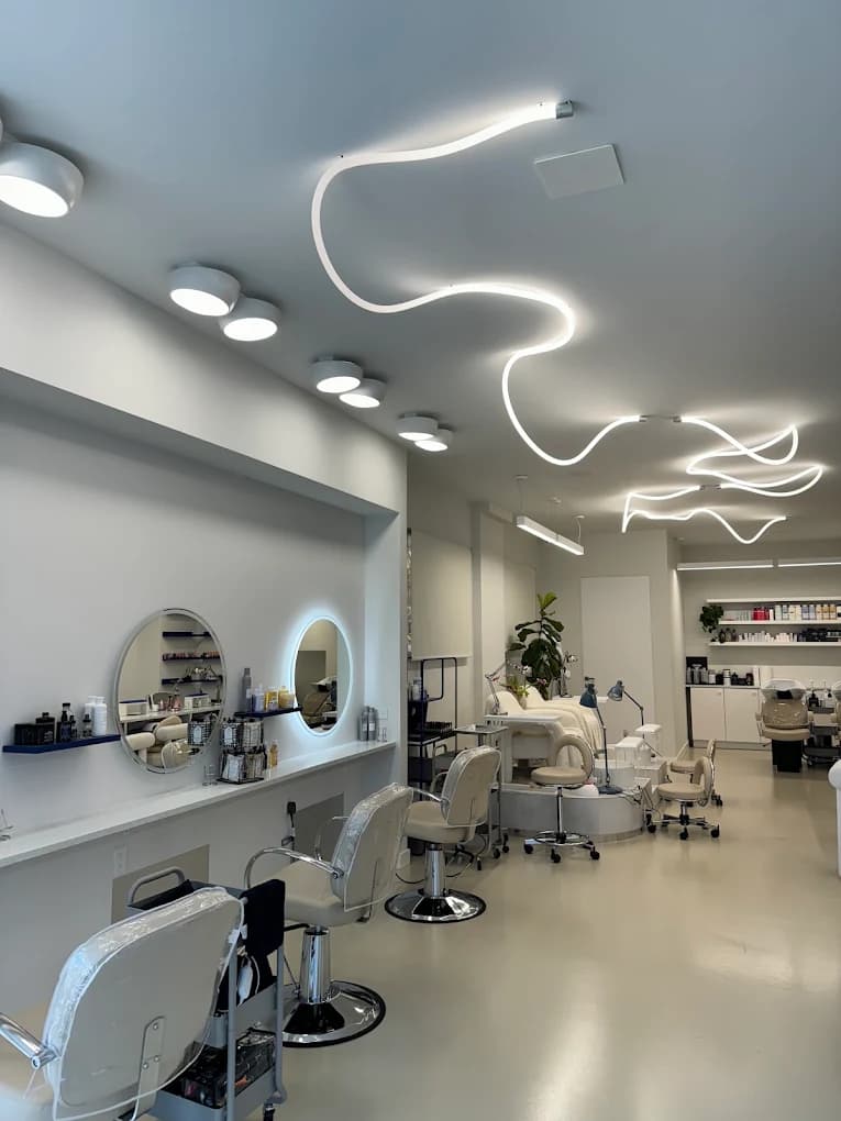Sugarboo hair salon interior with a white ribbon light sculpture across the ceiling